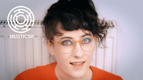 Meljoann poses in front of a bare radiator, aside a Mustics logo. 