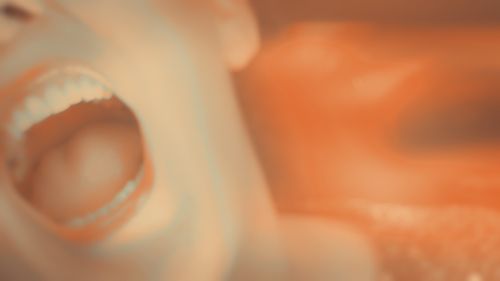 Meljoann's mouth screaming, with plentiful lens flares