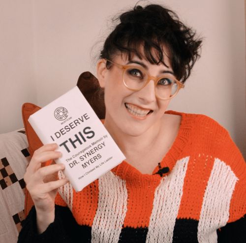 Promotional photo of Meljoann holding her boss' memoir: “I Deserve This, by Dr Synergy Myers”